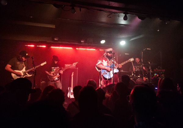 Photo of the band, Troy Kingi, The Cactus Handshake on a stage in a small club
